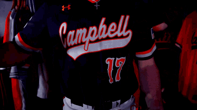 a baseball player wearing a campbell jersey holds a ball