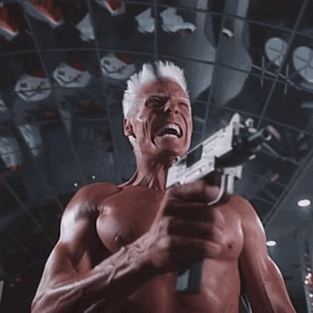 a man without a shirt is holding a hammer in his hand