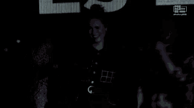 a woman is dancing in front of a pre party sign