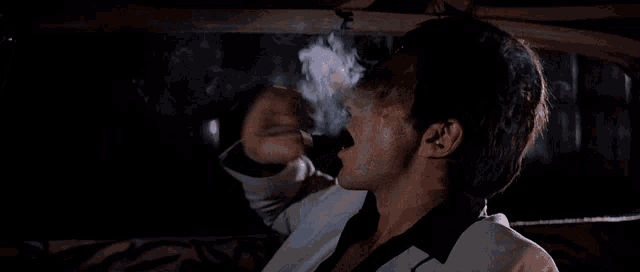 a man with smoke coming out of his mouth says ey!