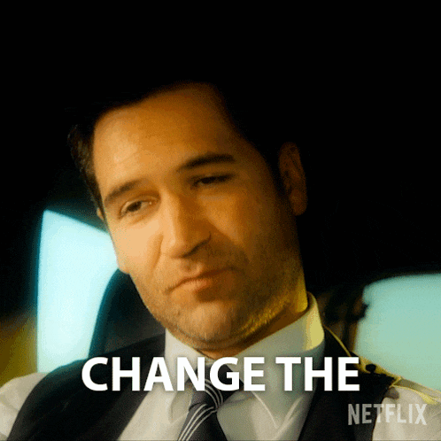 a man in a suit and tie says change the netflix logo in the corner