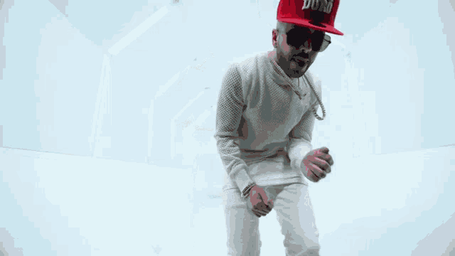 a man wearing a red hat that says supreme mind is dancing