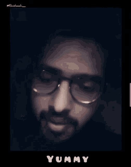 a man with glasses and a beard says yummy in white letters