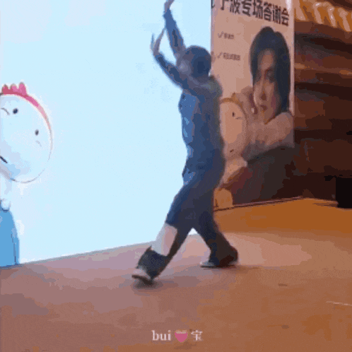 a man is dancing in front of a sign that says " bui "