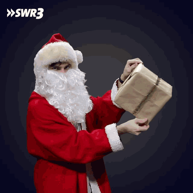 a man dressed as santa claus is holding a gift box in front of a swr3 logo