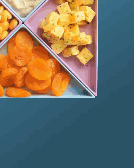 a variety of fruits and nuts are arranged in a triangle