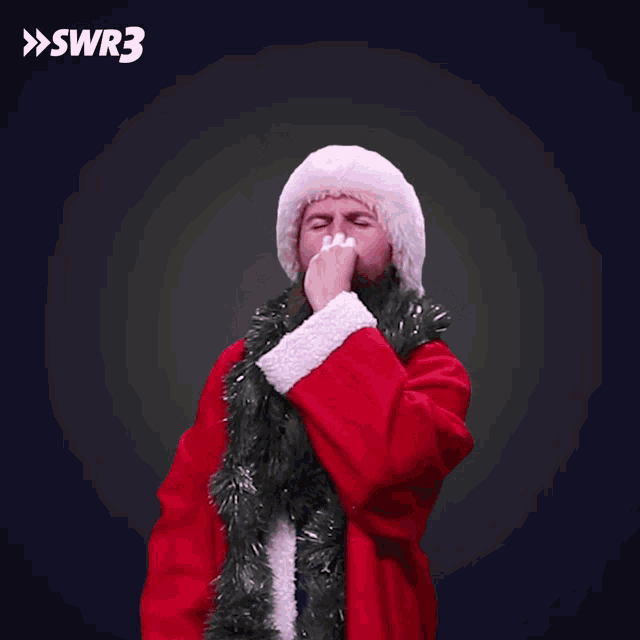 a man in a santa suit is dancing with a swr3 logo in the background