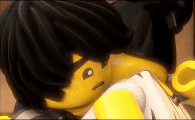 a close up of a couple of lego figures hugging each other