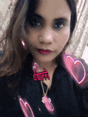 a woman is wearing a black shirt and a necklace with hearts around her and a sticker that says ' a '