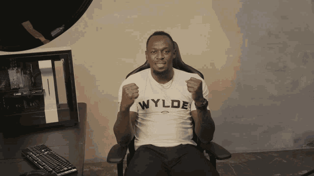 a man wearing a white t-shirt that says ' wylde ' on it