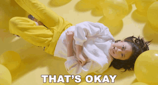 a girl laying on the floor with the words that 's okay written on the bottom