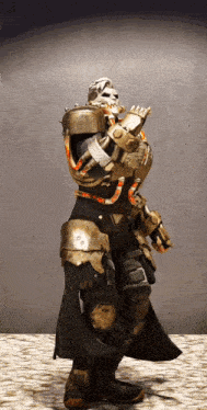 a man in armor with a skull on his face is standing on a cobblestone floor