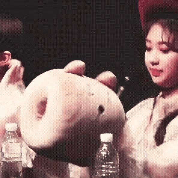 a woman in a red hat is holding a large donut