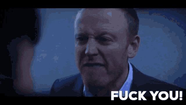 a close up of a man 's face with the words fuck you below him