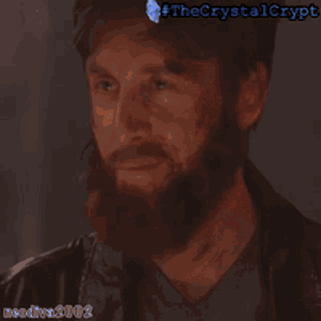 a man with a beard is wearing a leather jacket