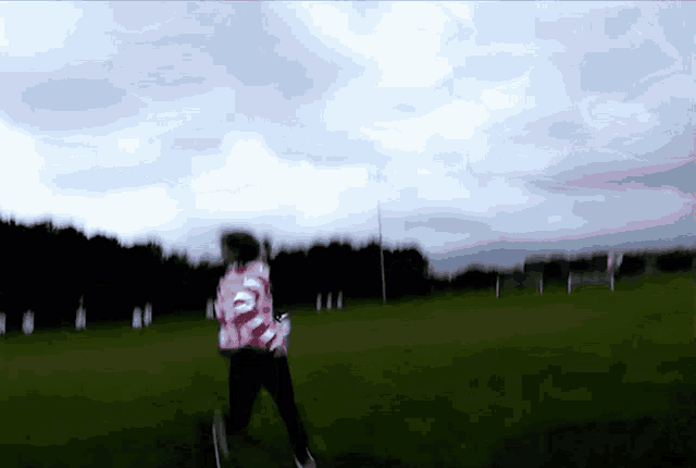 a blurry picture of a person walking on a field