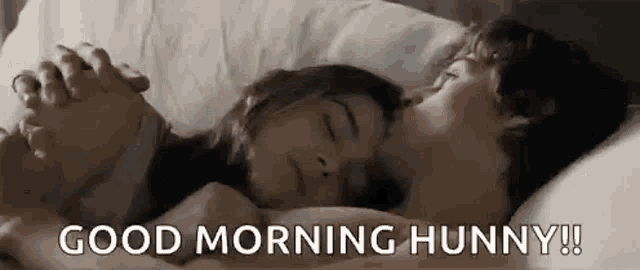 a man and a woman are sleeping in a bed with their hands folded in prayer .