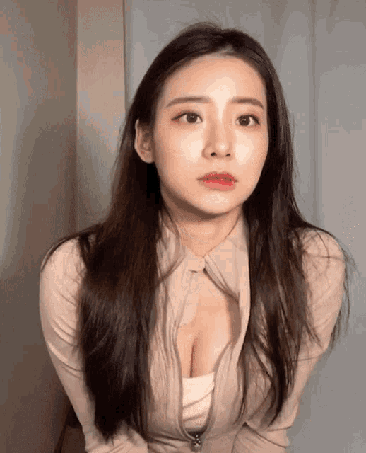 a woman with long hair is wearing a sweater with a zipper on the front