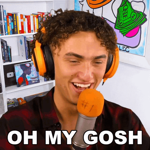 a man wearing headphones and a microphone says oh my gosh # 1
