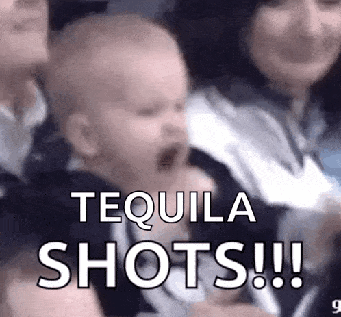 a baby is screaming in a crowd of people while holding a bottle of tequila .