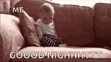 a baby is sitting on a couch with the words `` good night '' written on the bottom .