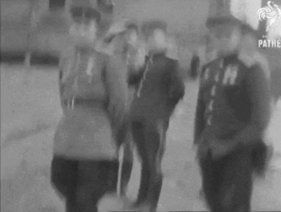 a black and white photo of a group of men in uniform standing next to each other .
