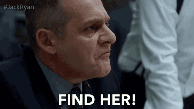 a man in a suit is saying find her