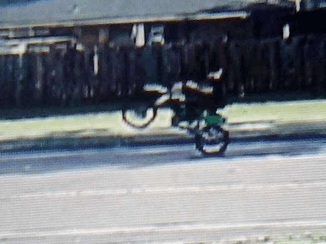 a blurred image of a person riding a motorcycle