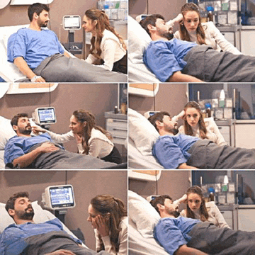 a man is laying in a hospital bed talking to a woman and a monitor shows that he has a fever