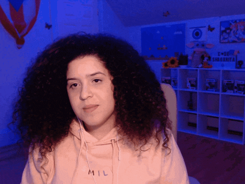a woman wearing a hoodie that says mil on it