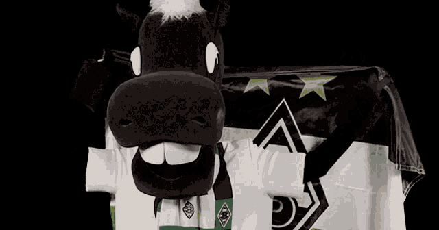 a black and white horse mascot holding a flag with the letter b on it
