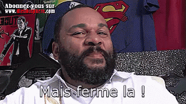a man with a beard says " mais ferme la "