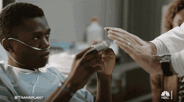 a man in a hospital bed with the hashtag #transplant on the bottom