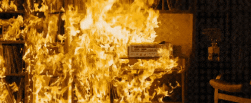 a room that is on fire with a record player on the table