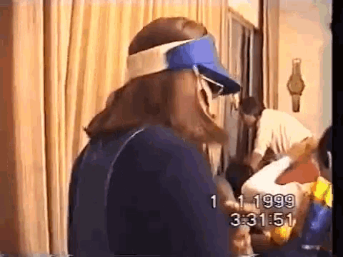 a woman wearing a blue visor is standing in a room with the time of 3:31