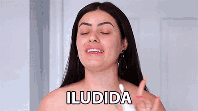 a woman with her eyes closed has the word iludida written on her chest