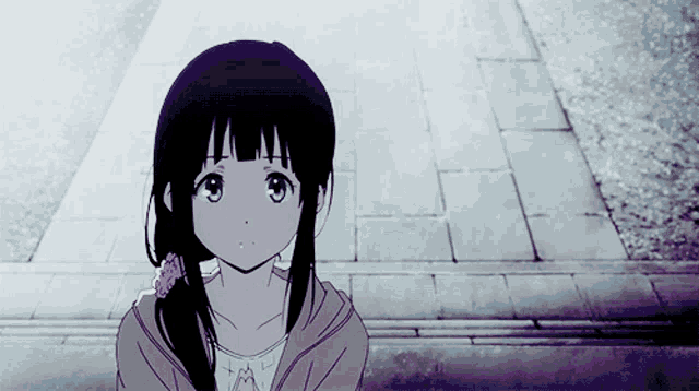 a girl with a ponytail and a flower in her hair stands on a sidewalk