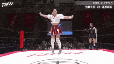 two women in a wrestling ring with jpw written on the top