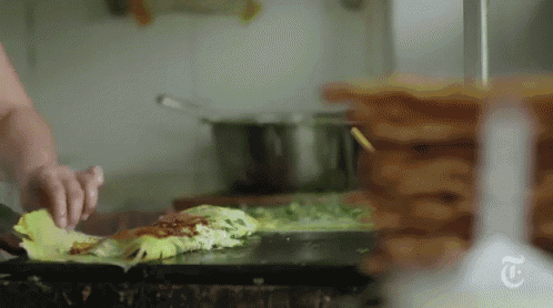 a close up of a person preparing food with a t on the bottom
