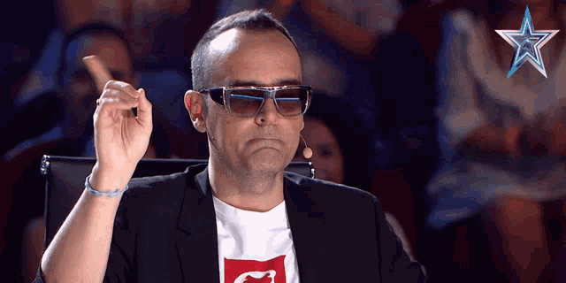 a man wearing sunglasses and a t-shirt that says g on it