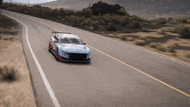 a hyundai race car is driving down a road
