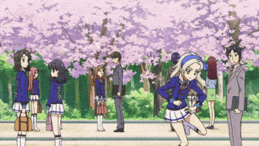 a group of people are standing in front of trees with flowers
