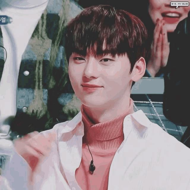 a young man wearing a pink turtleneck and a white shirt with a speech bubble that says " bye my blue "