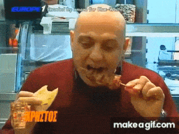a bald man is eating a piece of meat on a stick in front of a sign that says europe 1