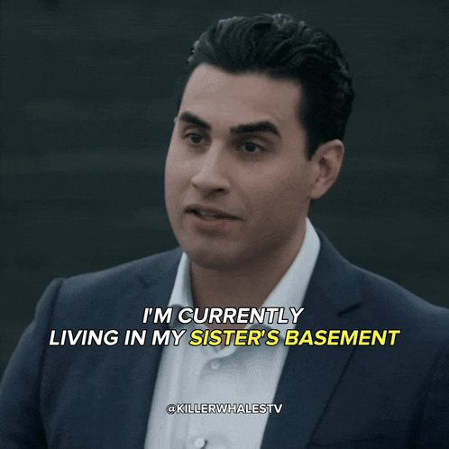 a man in a suit and white shirt is holding a can of soda and says um