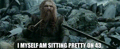 a man with a beard is holding a sword and says i myself am sitting pretty on 43.