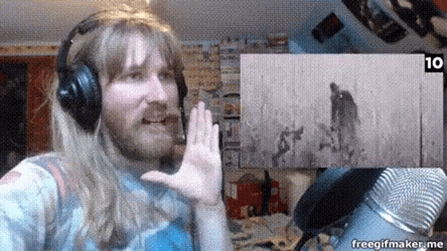 a man wearing headphones is waving his hand in front of a microphone with the number 10 on the bottom right