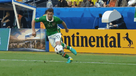 a soccer player kicks a ball in front of a continental sign