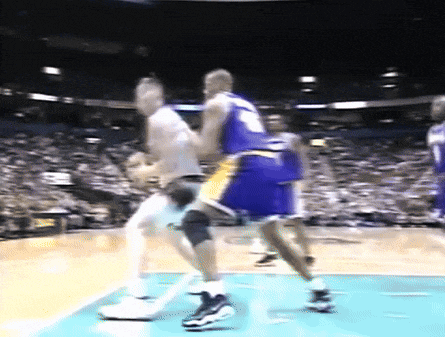 a blurry picture of a basketball game with a player wearing a jersey with the number 9 on it