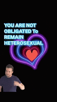 a man is standing in front of a neon heart that says you are not obligated to remain heterosexual